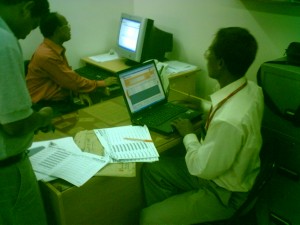 Manual hand typing of food distribution records into Jibon OJibaka database at Barisal district office